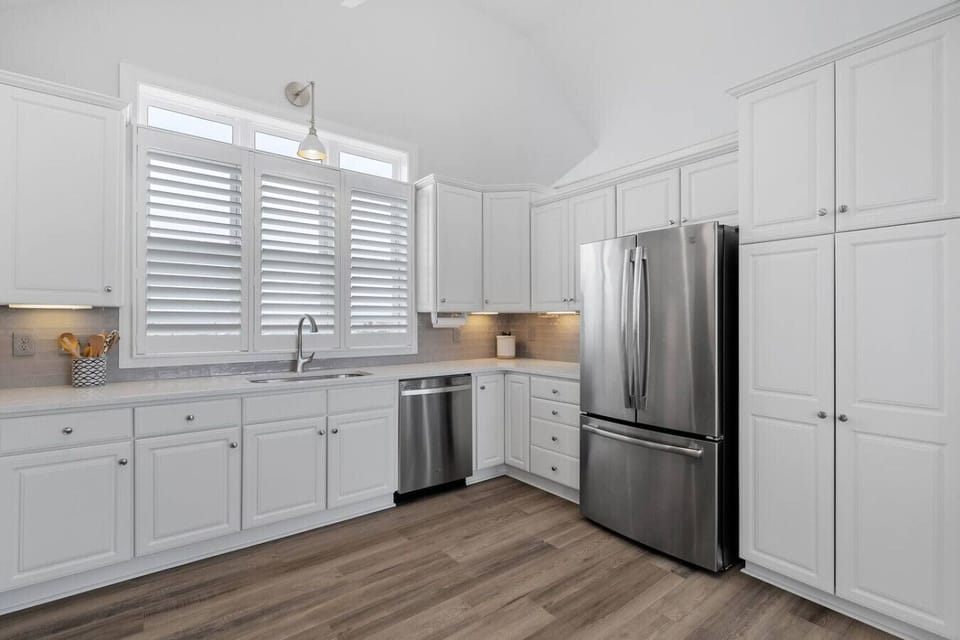 Beautifully updated kitchen with ample counter space, stainless appliances, and coastal-inspired finishes.