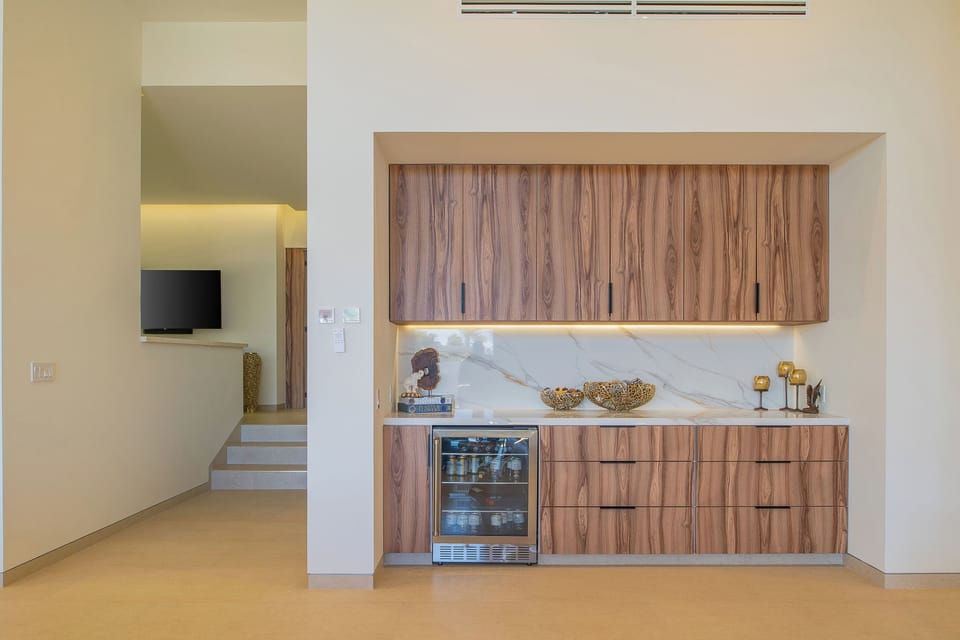 Your sleek kitchenette features beautiful wood cabinetry, marble countertops, and modern appliances for convenient meal prep.