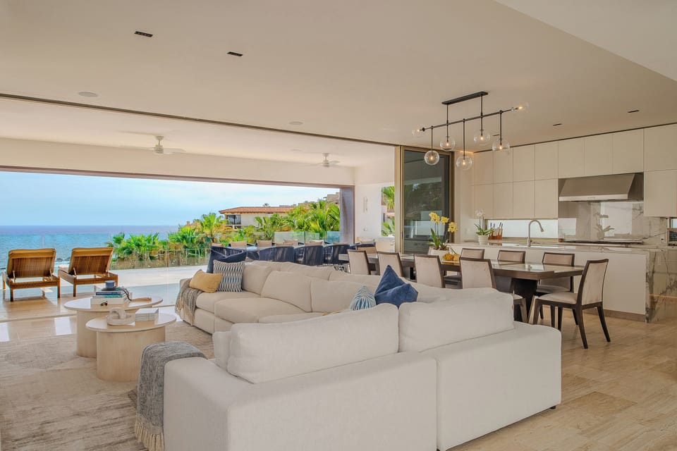 Unwind in this sophisticated open-plan living space where your ocean views stretch endlessly beyond plush seating and a modern kitchen.