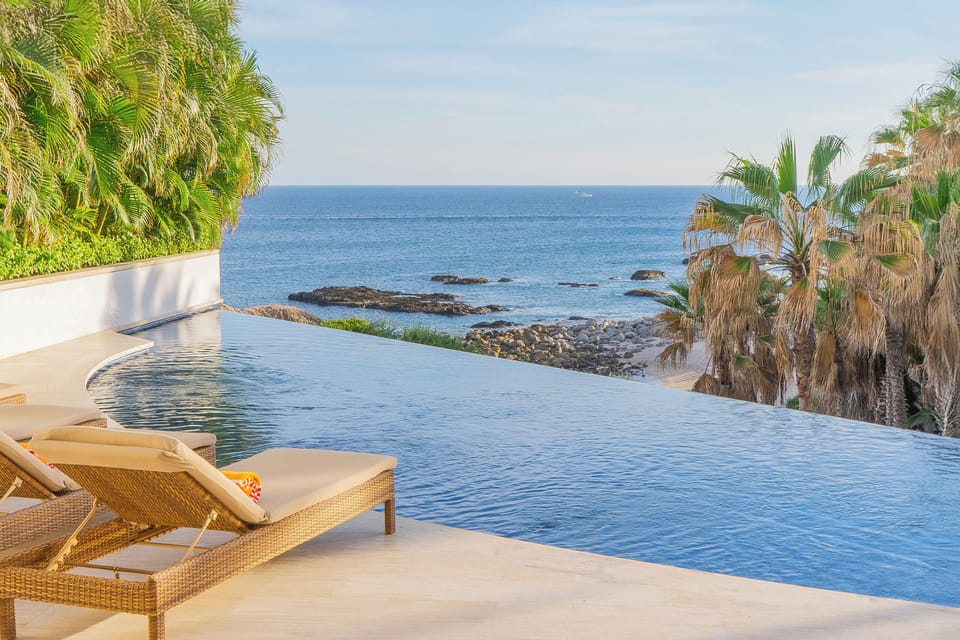 Relax on luxurious poolside loungers while soaking in breathtaking ocean views from your private infinity pool paradise.