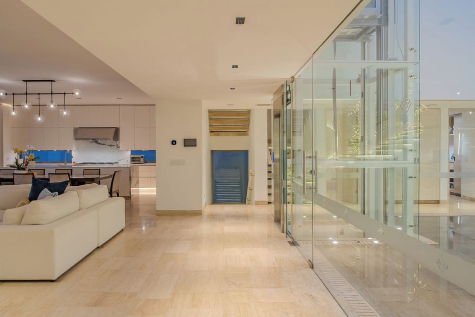 Step into your luxurious modern sanctuary where sleek glass elevators and polished floors create an atmosphere of sophisticated comfort.