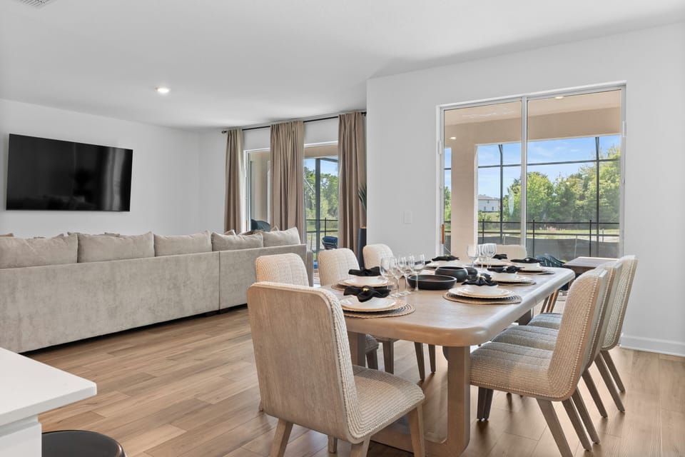 Gather around your spacious dining table for memorable meals, with sunlight streaming through large windows and cozy seating just steps away.