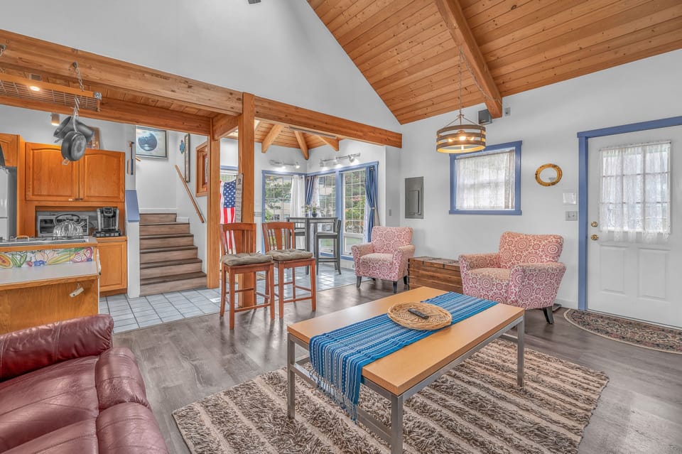 Relax in your spacious living room with soaring wood beam ceilings, cozy seating, and an open layout perfect for gathering.