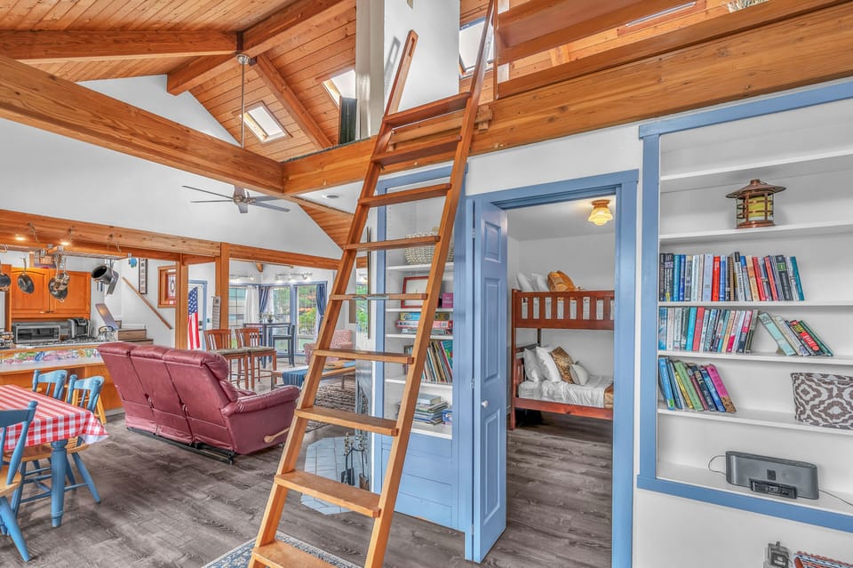 Climb up to your cozy loft retreat while kids enjoy the charming bunk bed nook below—this open-concept space blends rustic warmth with playful comfort.