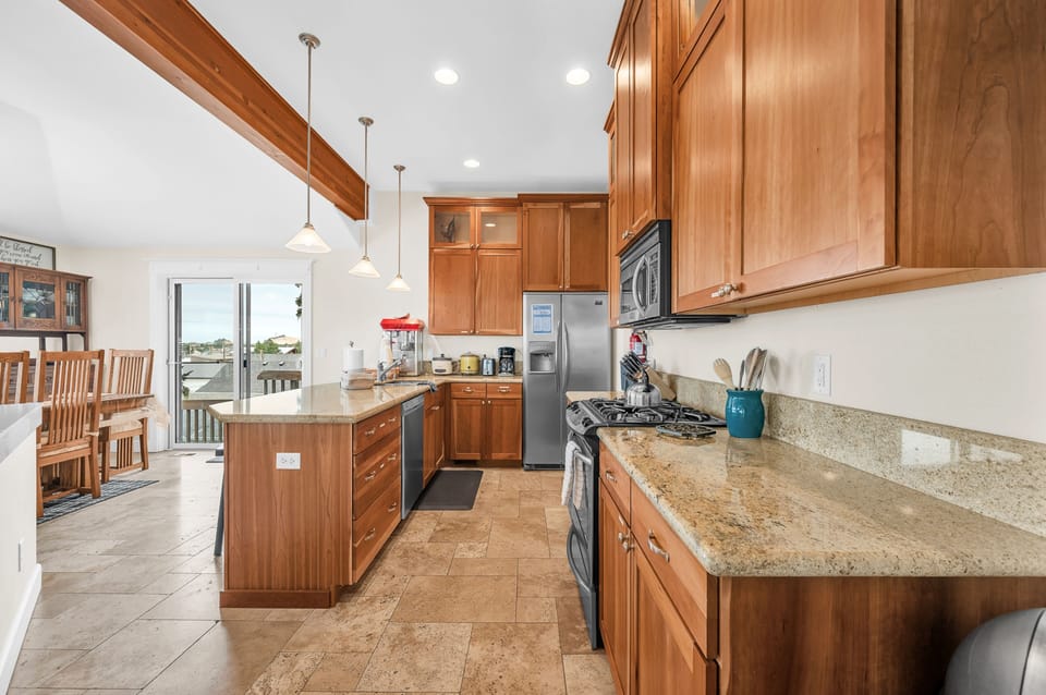 Your spacious kitchen welcomes you with warm wood cabinets, granite counters, and stainless appliances—perfect for preparing meals together.