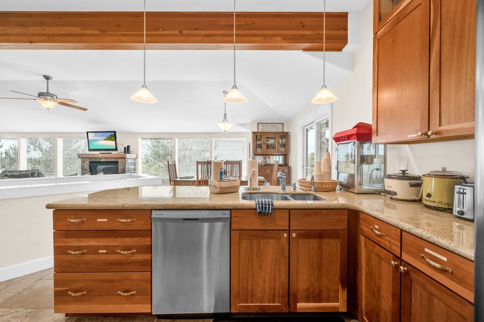 Your gourmet kitchen awaits with granite countertops, rich wood cabinetry, and modern appliances—perfect for creating memorable meals together.