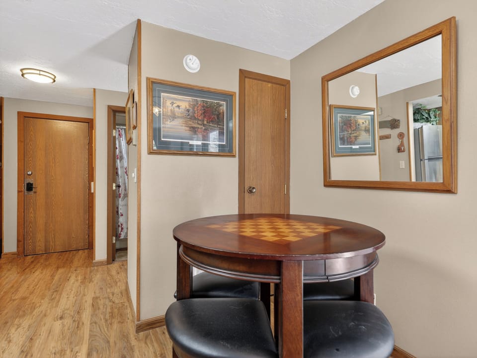 Gather around your elegant dining table with built-in seating, perfect for intimate meals and game nights in this thoughtfully designed space.