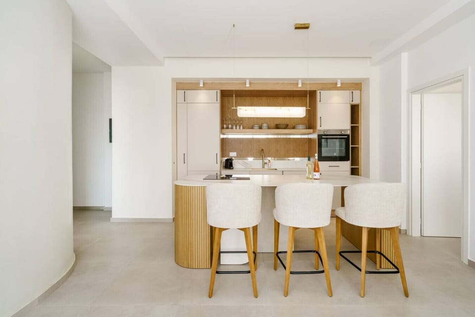 Modern fully equipped kitchen with a breakfast bar, perfect for cooking and enjoying meals in Crete.