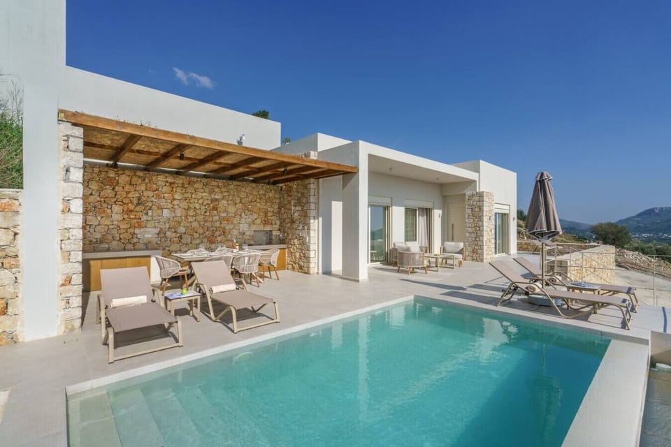 Enjoy a luxurious pool experience with comfortable loungers and umbrellas.