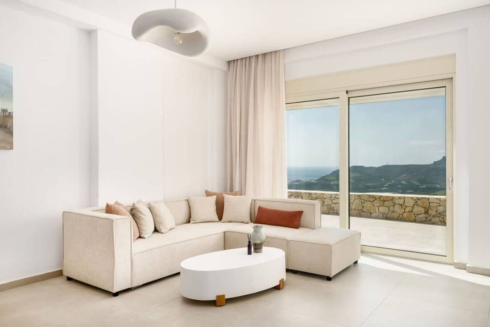 Bright and airy lounge with comfortable seating, a smart TV, and an amazing sea view.
