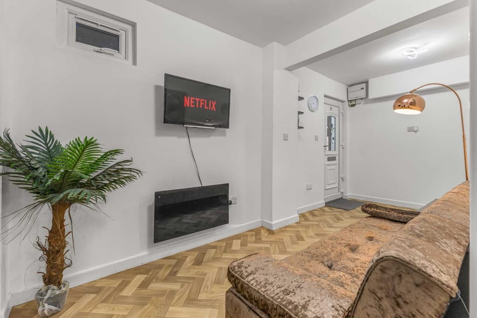 Living Room: Stylish decor meets modern comfort with art, light, and easy access to the kitchen!