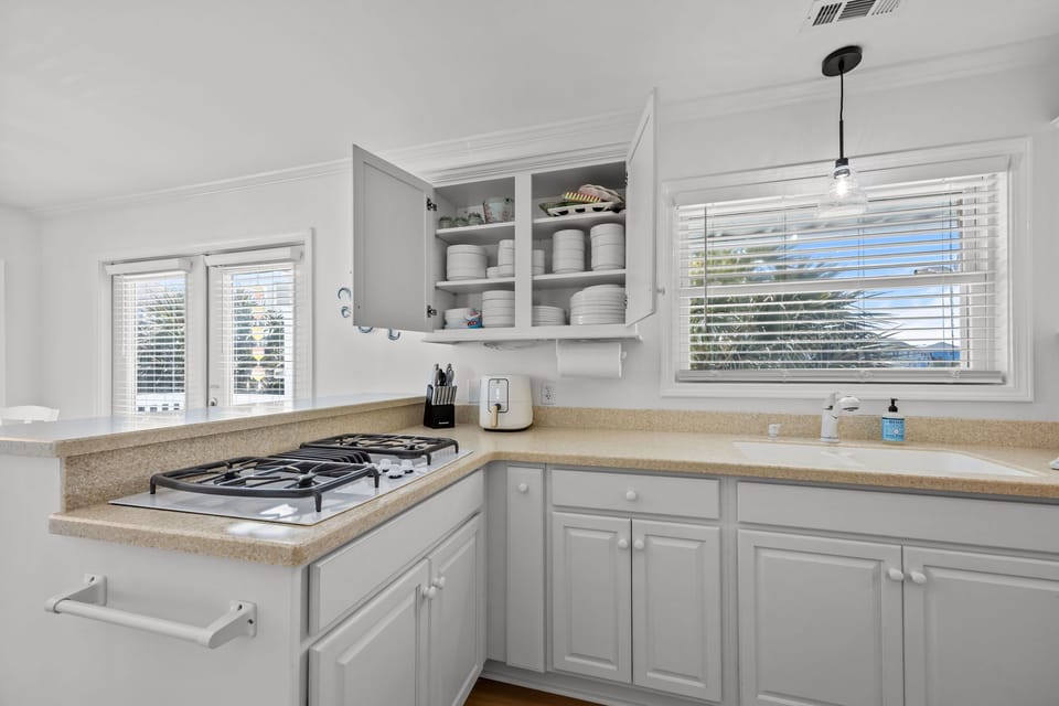 Stocked cabinets with dishes, cookware, and kitchen essentials for easy meals at home