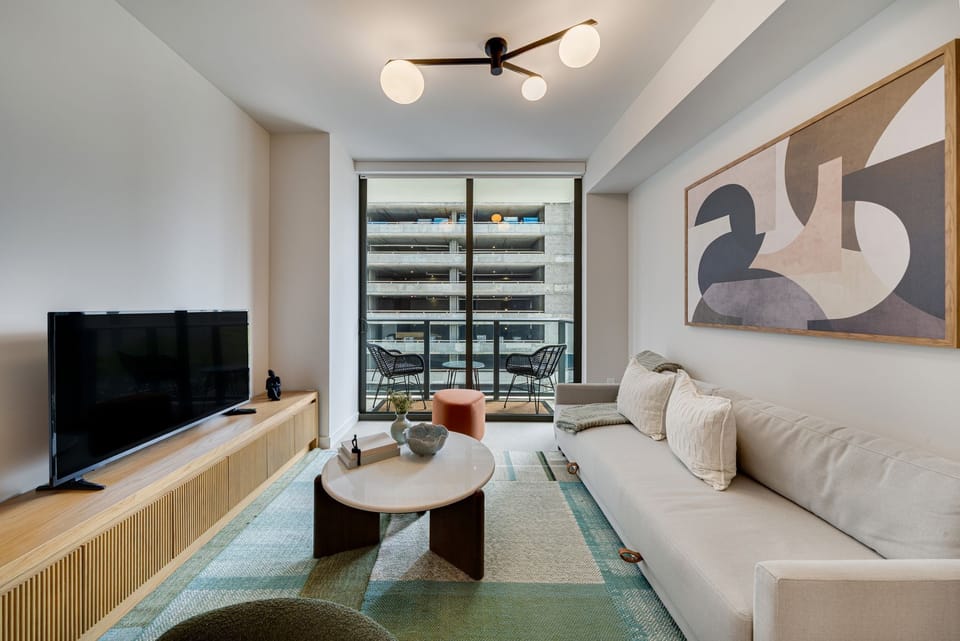 Spacious living room with natural light and balcony access