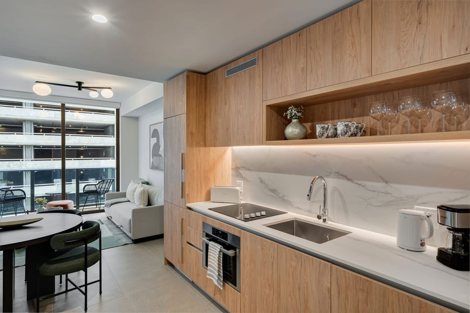 Fully equipped kitchen featuring minimalist design.