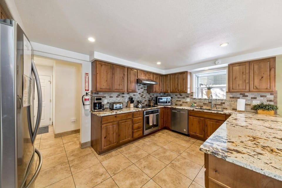 Spacious kitchen with granite countertops and stainless steel appliances