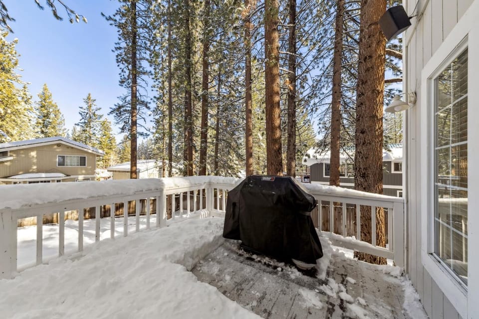 Cozy snowy deck with grill, perfect for winter gatherings