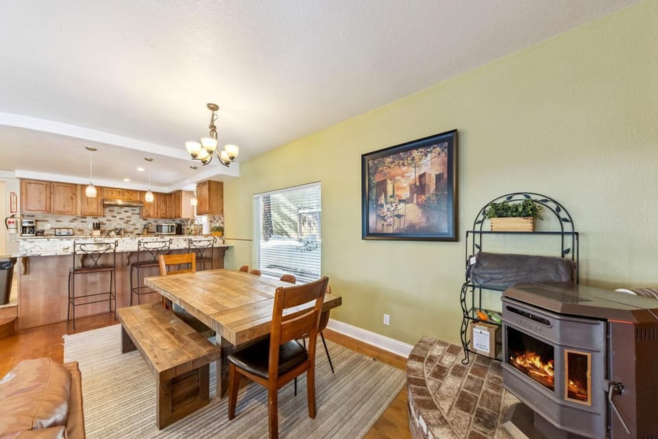 Cozy dining area with wood stove and open kitchen view