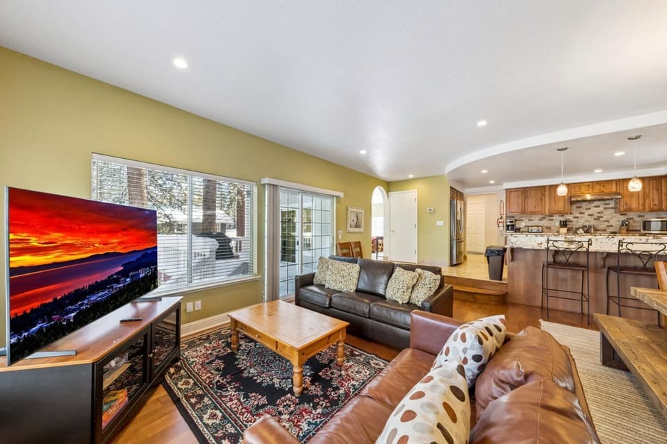 Spacious living room with cozy seating and vibrant sunset views