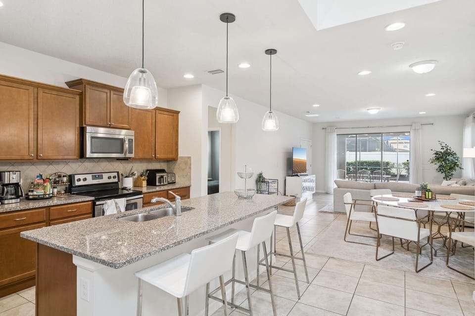 Spacious kitchen and dining area with modern finishes and natural light