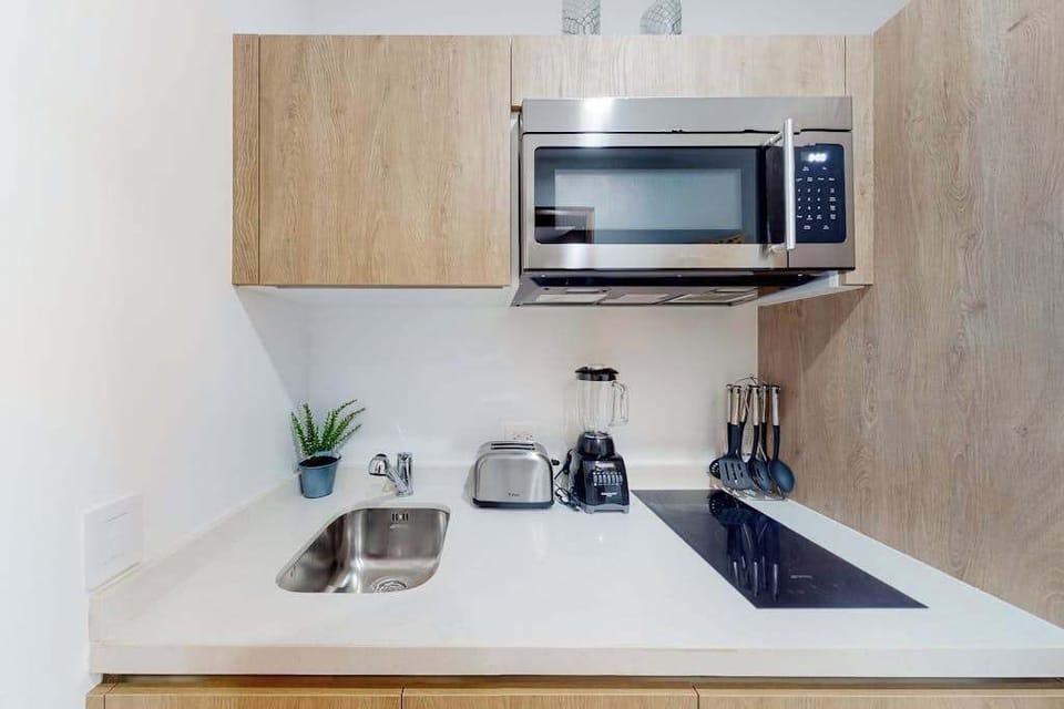 Fully equipped kitchen with microwave and stovetop