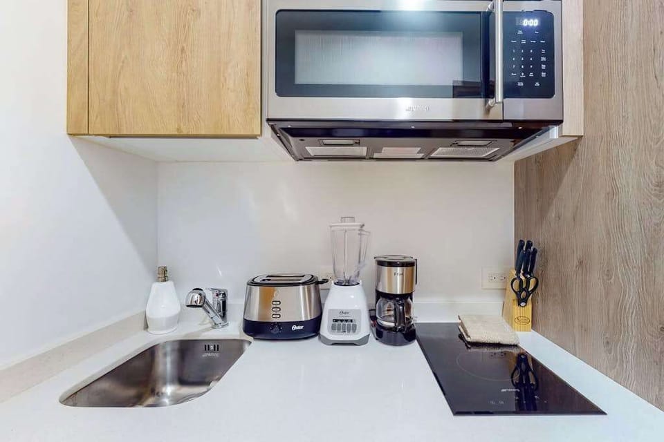 Fully equipped kitchen with stovetop and microwave
