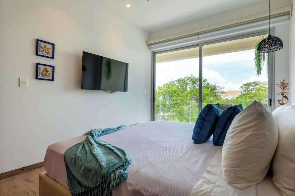 Master bedroom with king bed and balcony