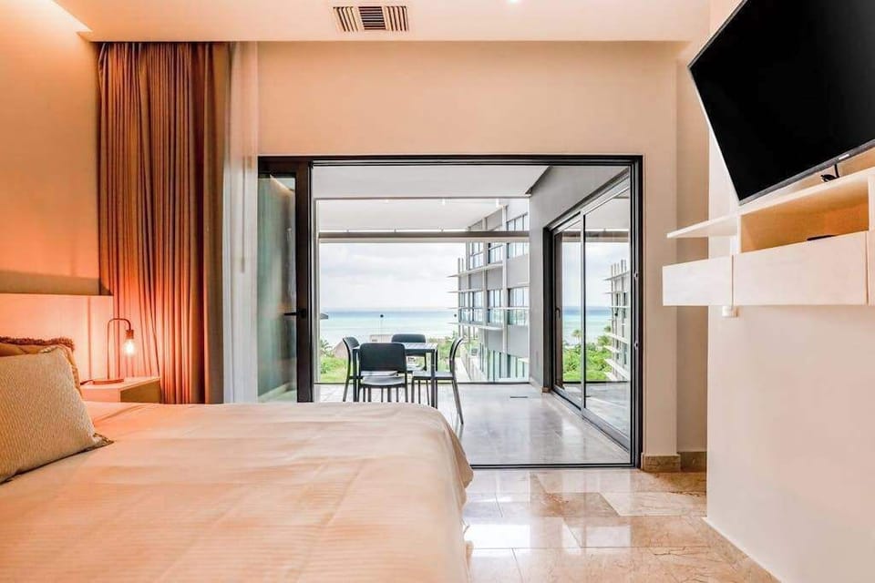 Open living and dining area opening to the ocean-view balcony