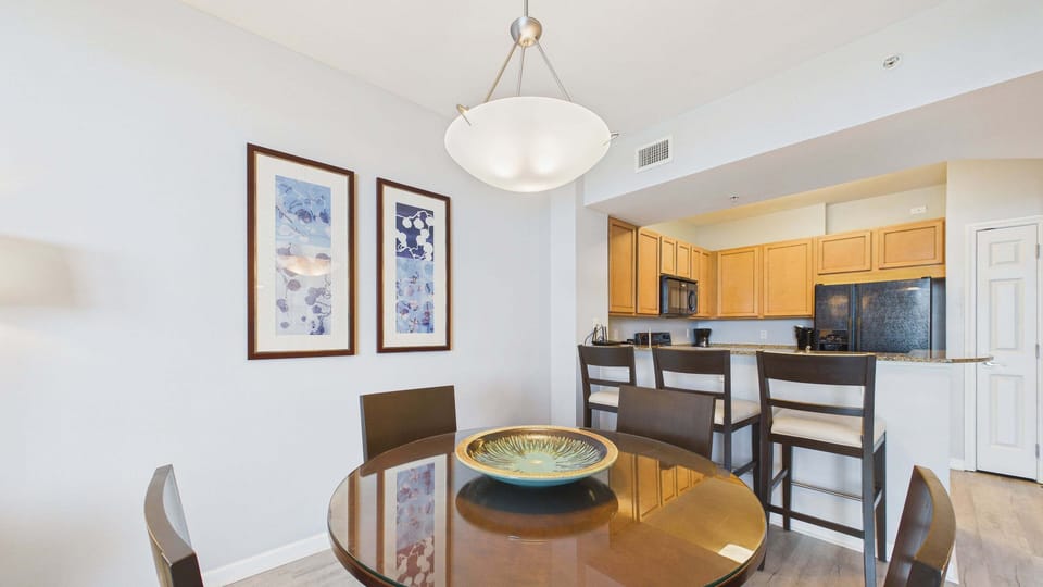 Dining table with seating for 4 and additional seating at breakfast bar