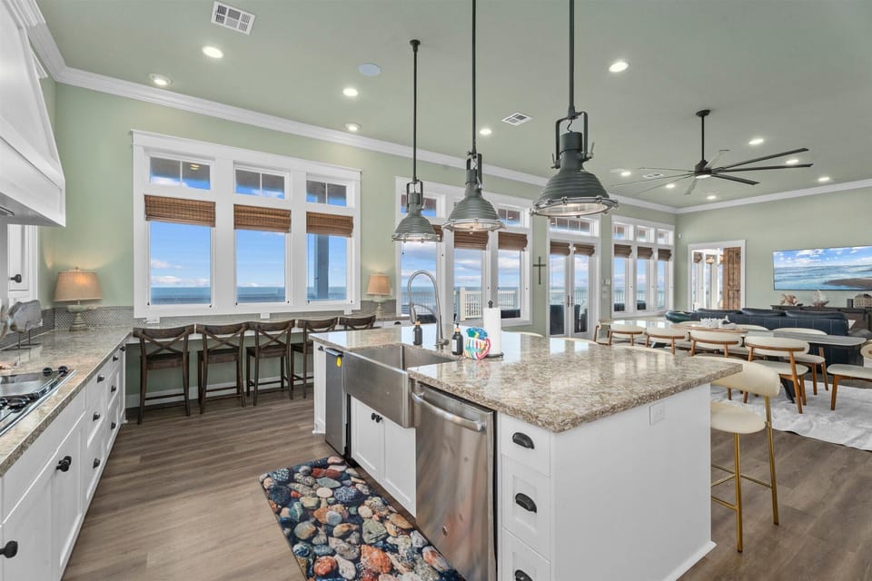 Gourmet kitchen with large island, seating, and coastal décor – high-end vacation rental kitchen