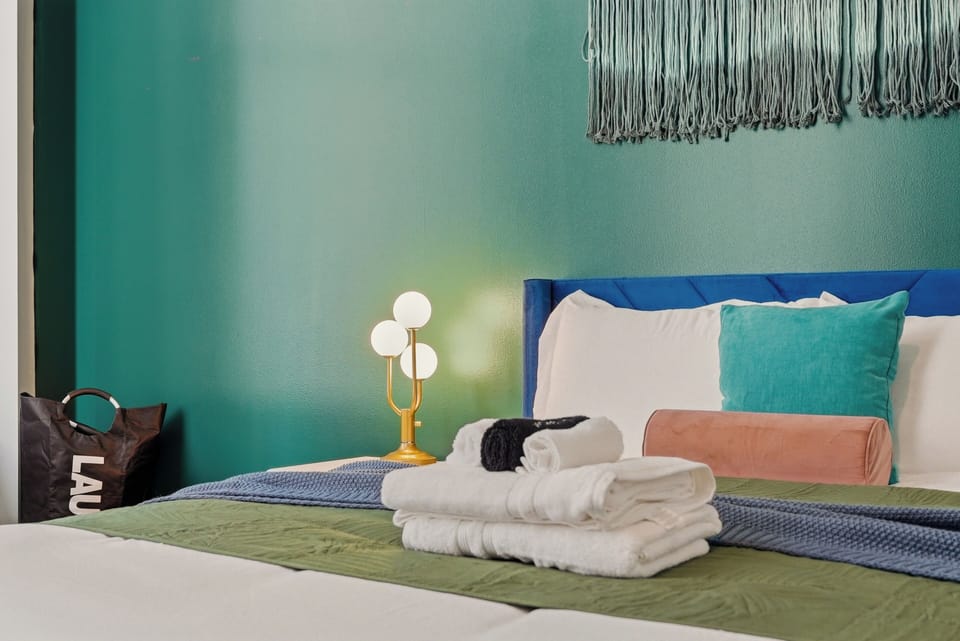 Colorful, cozy bedroom with plush bedding and fresh linens.