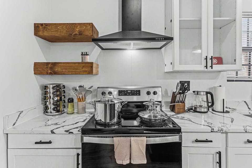 Enjoy cooking in this well-designed kitchen with sleek countertops and top-of-the-line appliances, perfect for creating your favorite dishes.
