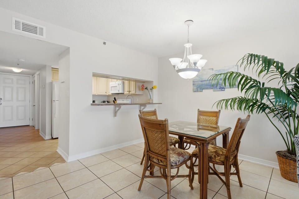 Ocean Breeze E702- Gather around the dining table for meals, with an open layout that flows seamlessly into the kitchen, brightened by natural light and tropical accents.