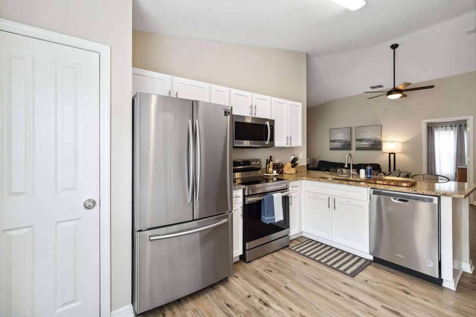 Bright and fully equipped kitchen with granite counters and stainless steel appliances