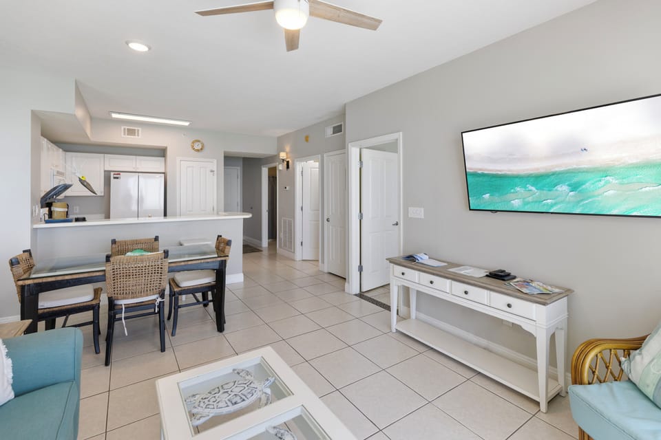 Relax in your bright, airy living space with coastal touches and ocean artwork that sets the perfect beach getaway mood.