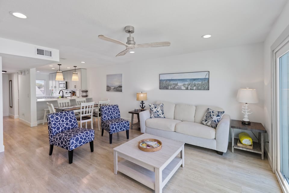 Unwind in your open-concept living and dining space, where calming coastal décor and modern comfort create the perfect home base for your beach getaway.