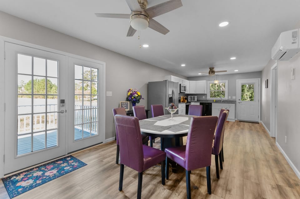 Dining Room: Bright space with stylish purple chairs, perfect for sharing meals and laughter!