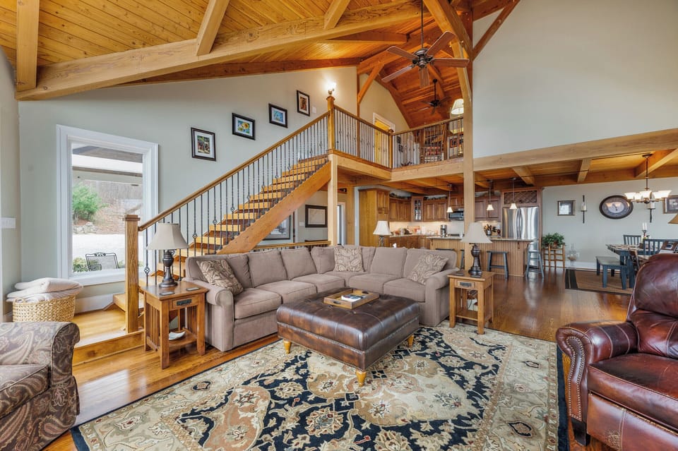 Living Room: Open spaces with elegant wood accents invite relaxation, High ceilings, warm gathering space, and connection! 