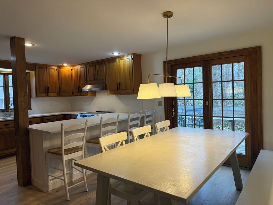 Kitchen with dining table and built in bench with walk out to deck