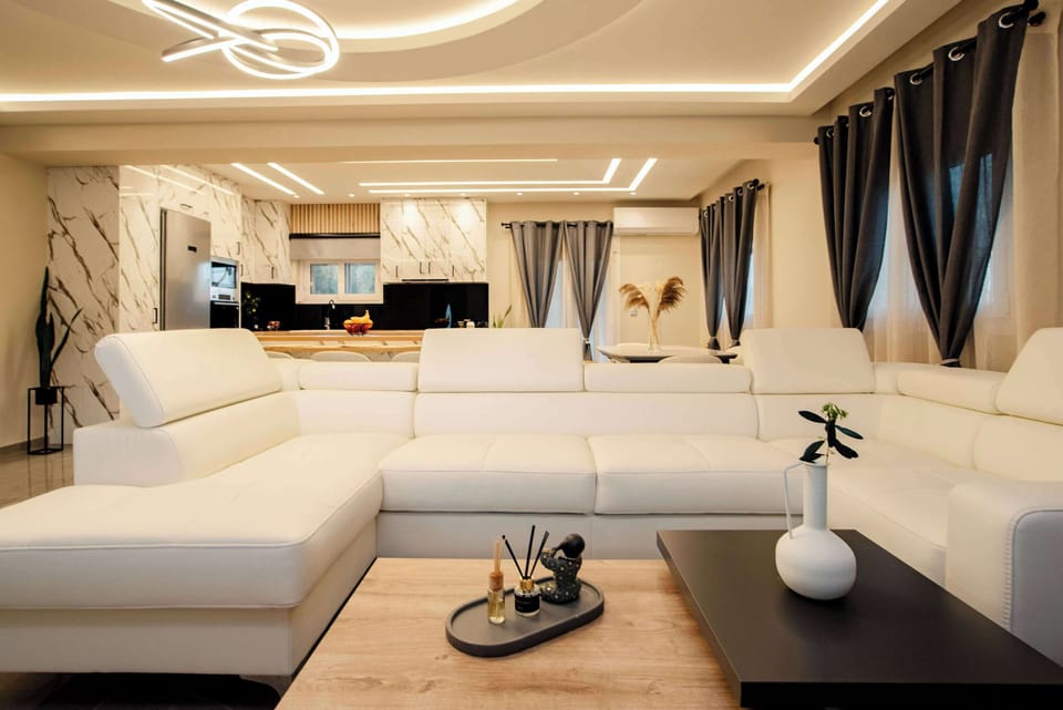 Spacious open-plan living room with soft lighting and luxury finishes
