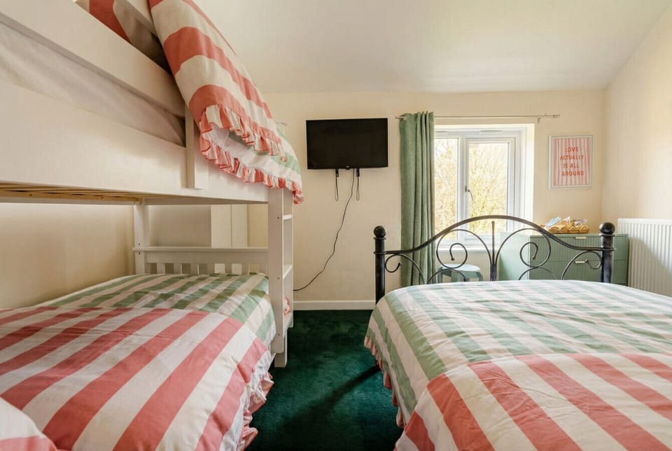Bunk beds plus a double mean the whole family sleeps comfortably together in one bright, cheerful room.