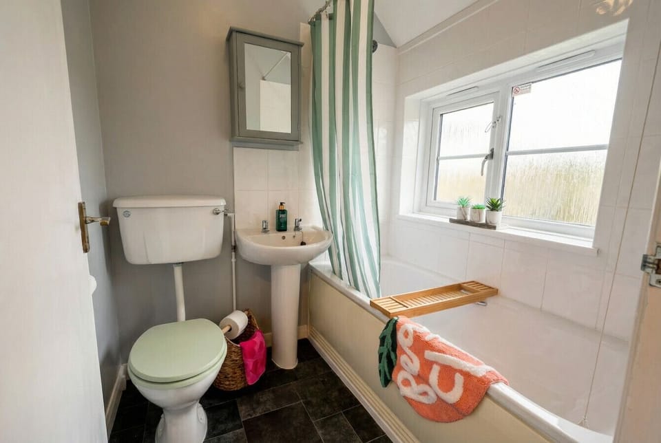 Soak away the day in the tub with a bamboo caddy, a garden outlook, and plenty of natural light.