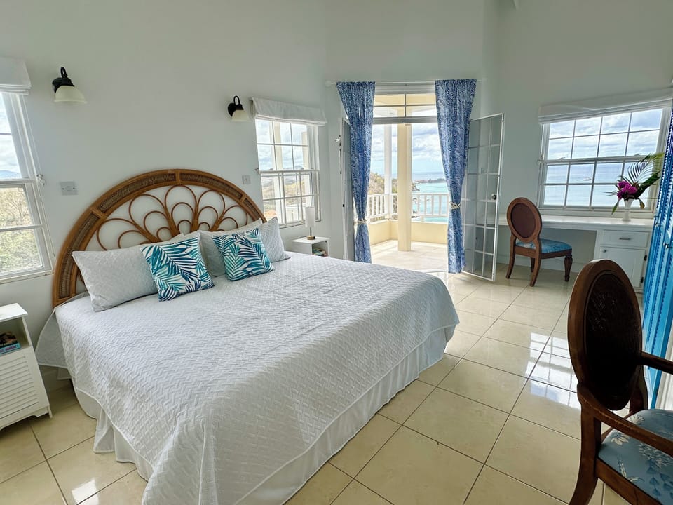 The Blue Room (King) with private balcony, double vanities, and twin airbed.