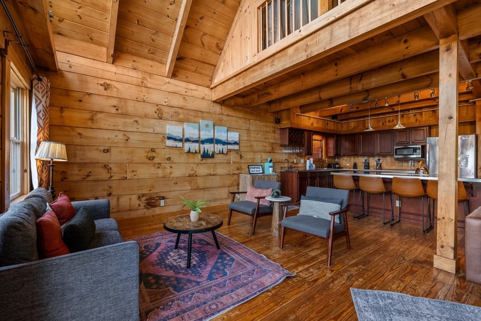 Vaulted timber ceilings and warm knotty pine give the living area that unmistakable Smoky Mountain lodge feel.