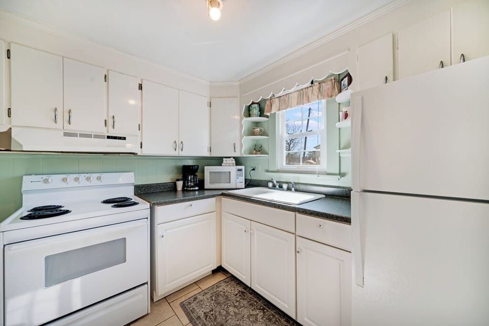 Beach white cabinetry and cool coastal colors team up with historic Chincoteague charm.