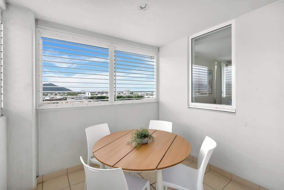 The main balcony is furnished with alfresco dining, offering the perfect spot to enjoy morning coffee or unwind with sweeping Cairns views.