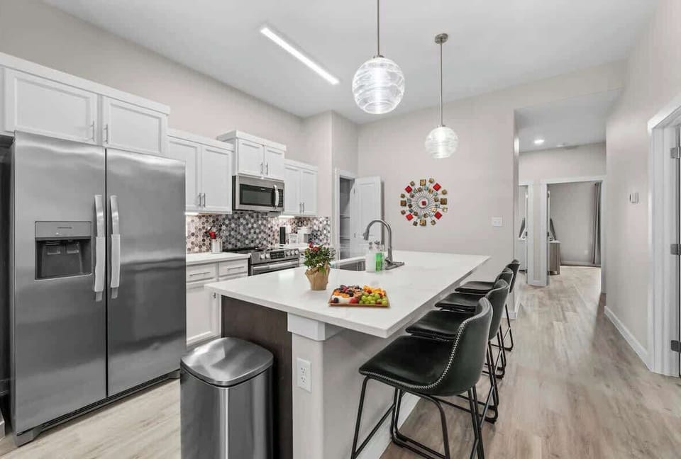 Explore this culinary masterpiece. Clean, simple lines, gorgeous backsplash, oversized kitchen island with seating for 4+ bonus of four seats at the table.

Stainless steel appliances and polished white countertops make this a perfect to entertain