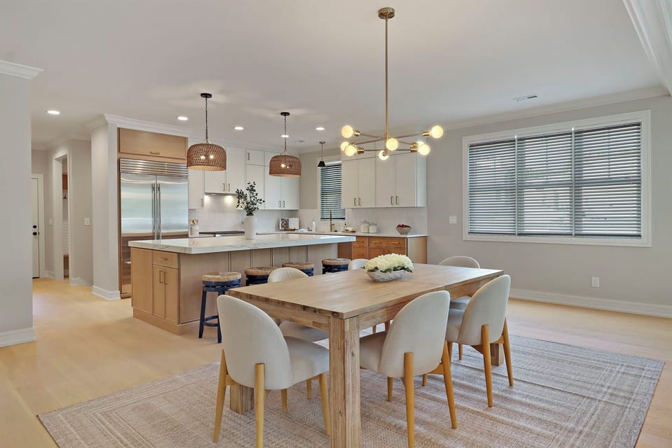Dining table with seats for 6, additional 4 spaces at the island.