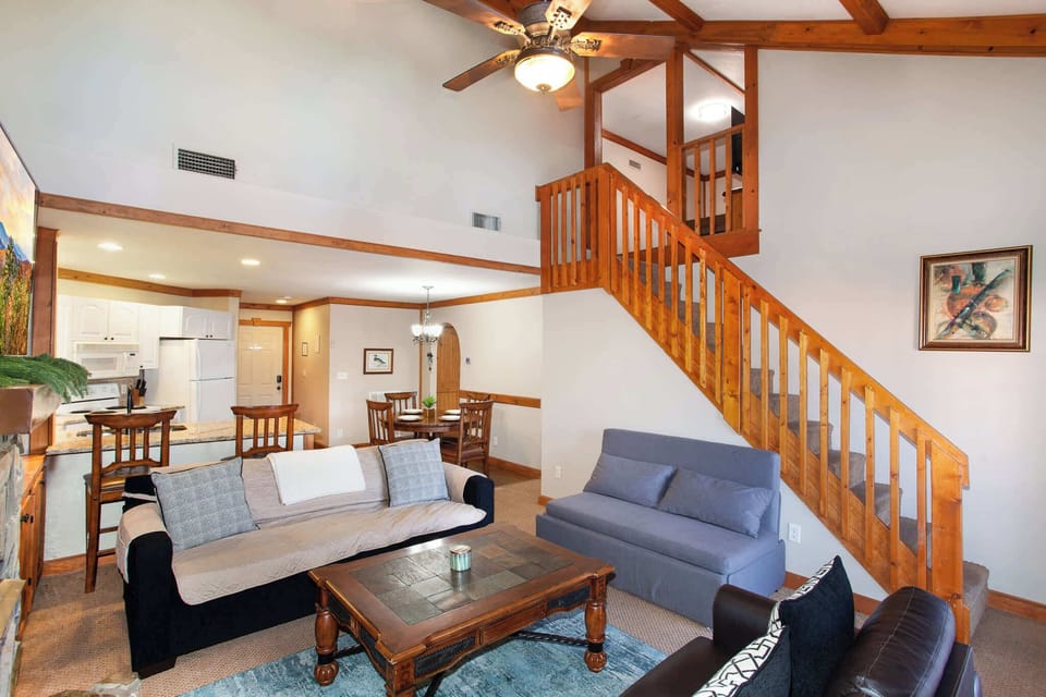 Cozy living room with stone fireplace and TV.