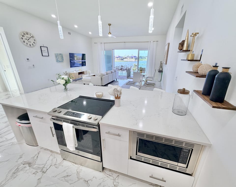Bright, modern kitchen with sleek appliances and water views