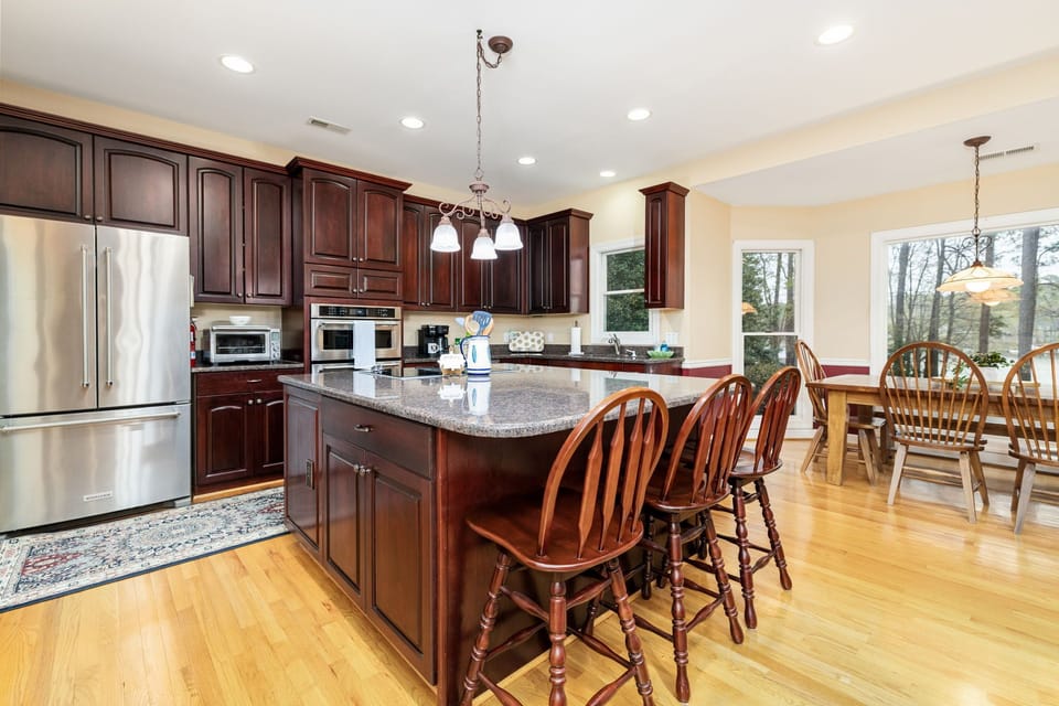 Fully equipped with island, bar seating, and pantry.